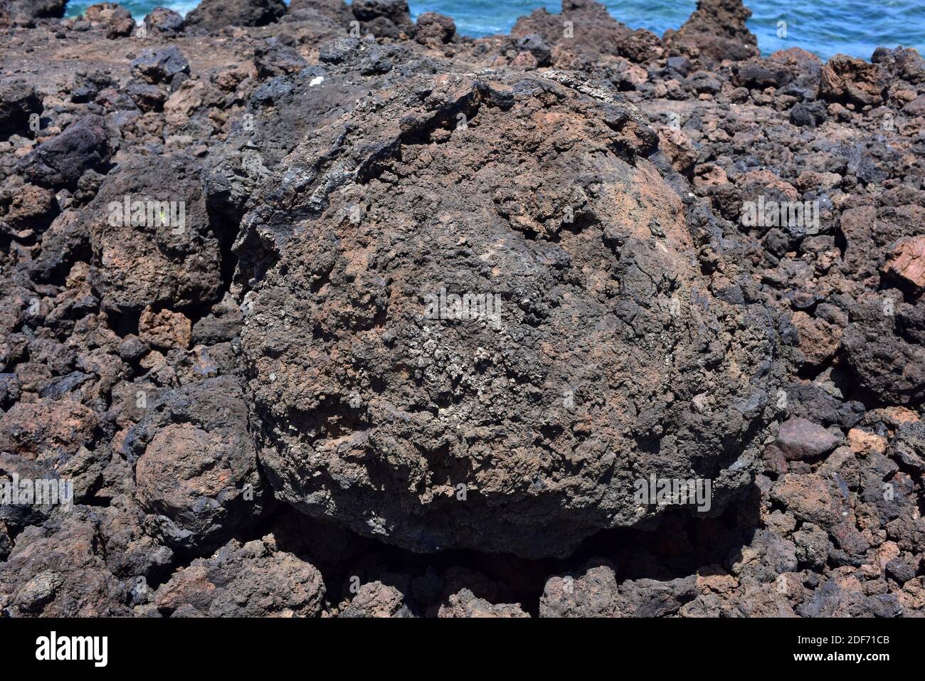 Volcanic bomb (bread-crust) is an extrusive igneous rock (pyroclast or tephra). This photo was taken in El Golfo, Lanzarote Island, Canary Islands, Stock Photo
