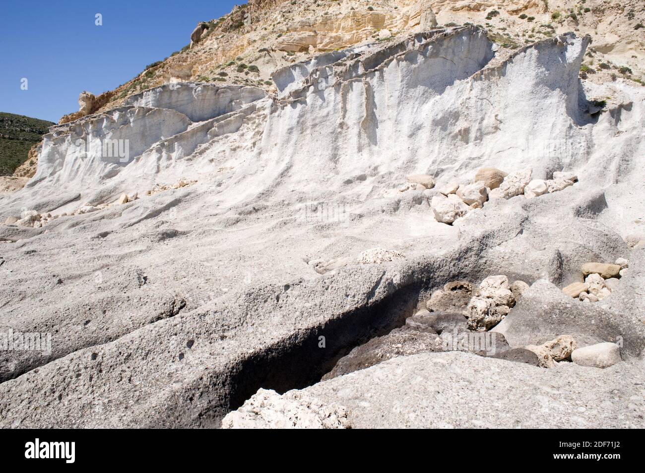 Ignimbrite is a deposit of pyroclastic flow (volcanic rock). This photo was taken in Cala del Plomo, Cabo de Gata Geopark, Almeria province, Stock Photo