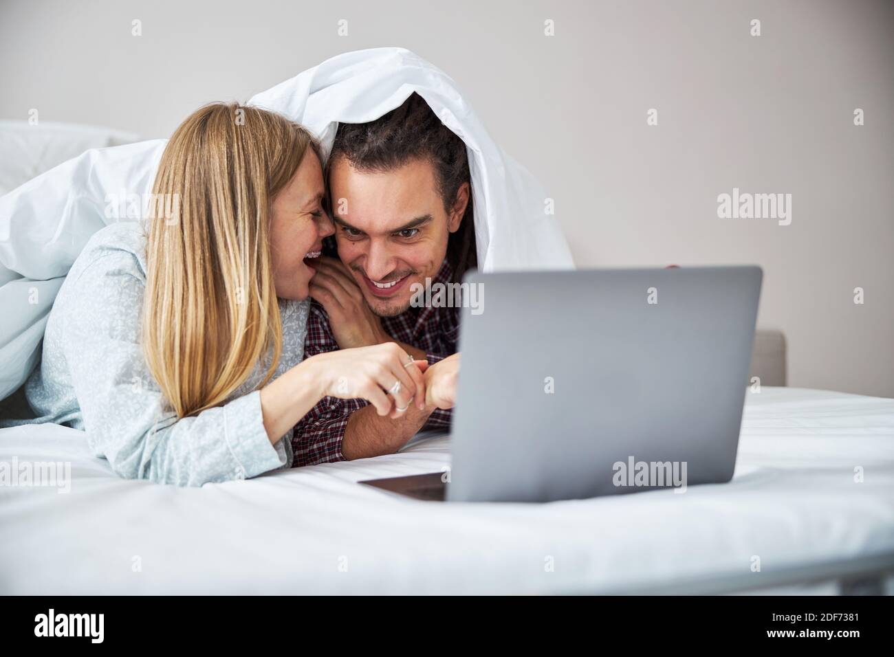 Happy young couple watching movie together on notebook Stock Photo - Alamy