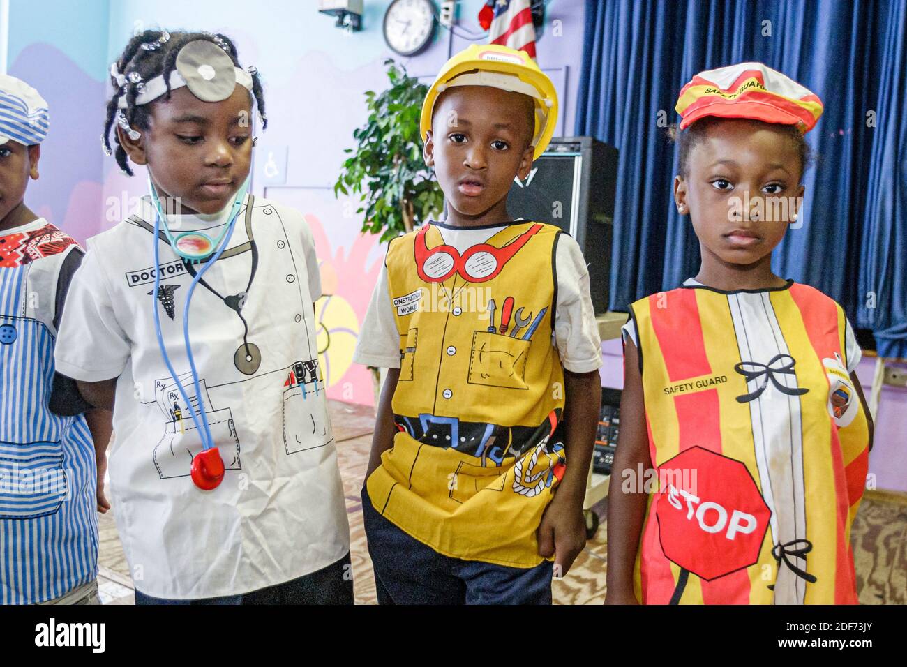 Miami Florida,Edison Park Elementary School Career Day,students Black girl boys wearing work clothes,doctor crossing guard construction worker Stock Photo