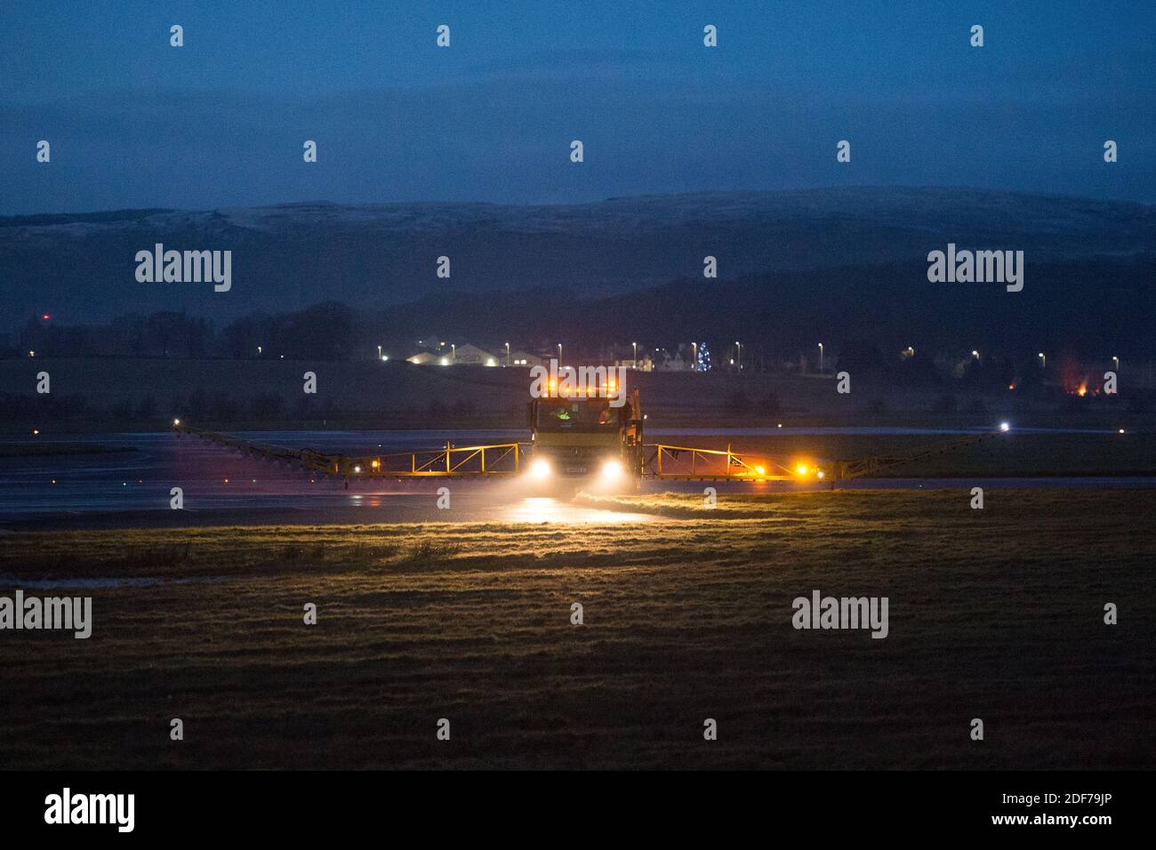 Glasgow, Scotland, UK. 3rd Dec, 2020. Pictured: A specialist airport ground vehicle, a Runway Deicer, which has massive arms on either side is seen spraying a solution of anti freeze out onto the airport runways and taxiways as snow and ice are forecast over the next 24 hours. The airport is gearing up for and weather and keeping safety a priority. Credit: Colin Fisher/17�Թ����� Live News Stock Photo