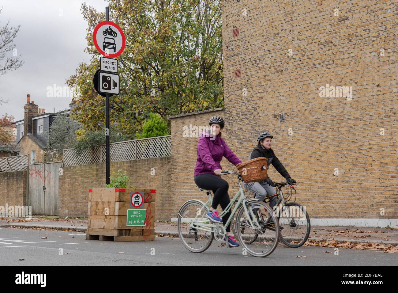 Two cyclists on Railton Road in Brixton, London in the United Kingdom