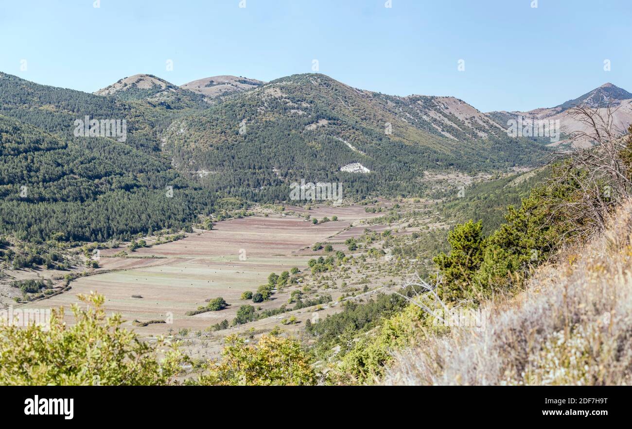 landscape with green upland valley, shot in bright light near Calascio, L'Aquila, Abruzzo, Italy Stock Photo