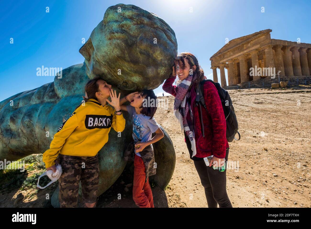 Italy, Sicily, Agrigento, Valley of the Temples, with the giant statue of Icarus fallen at the foot of the temple of Concordia Stock Photo