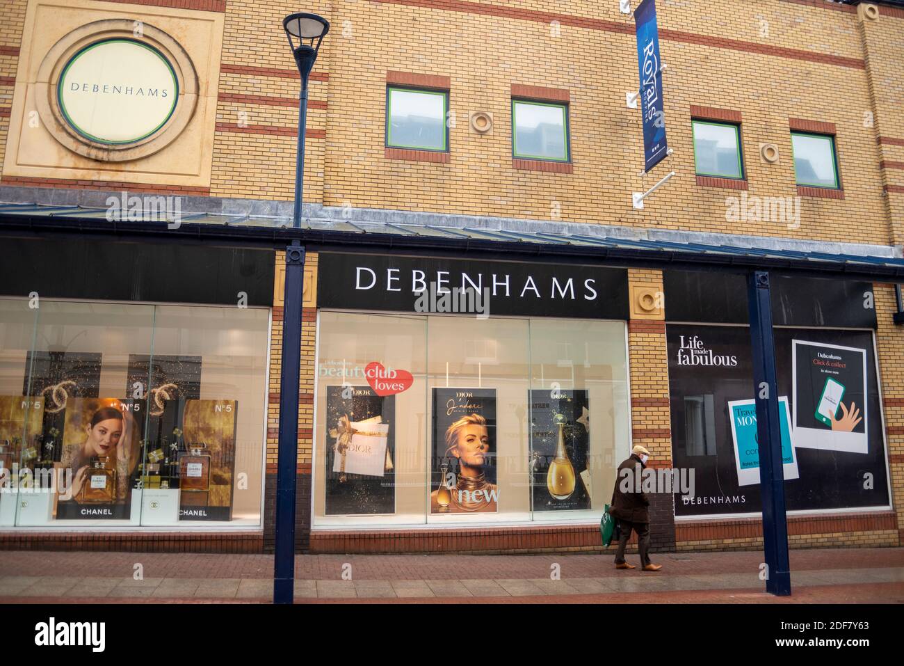 Debenhams in the Royals shopping centre in High Street, Southend on Sea, Essex, UK, in the run up to Christmas. Senior male shopper with face mask Stock Photo