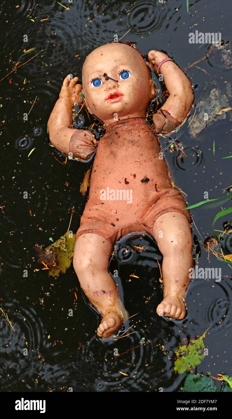 Spooky doll,drifting in canal,Bridgewater canal,higher Walton,Warrington,Cheshire,England,WA4 Stock Photo