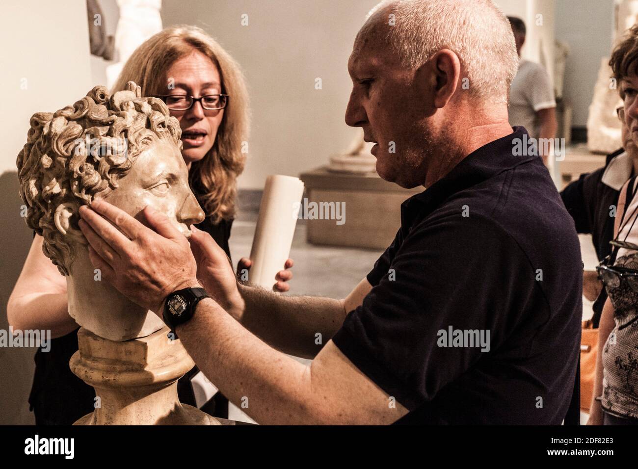 Group of blind people feeling the sculptures, National Archaeological Museum of Naples, Naples city, Campania, Italy, Europe. Stock Photo