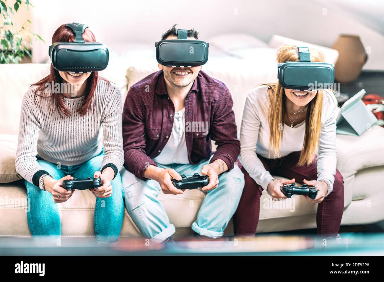 Millennial friends playing with vr glasses at home - Virtual reality and  wearable tech concept with young people having fun with headset goggles toy  Stock Photo - Alamy