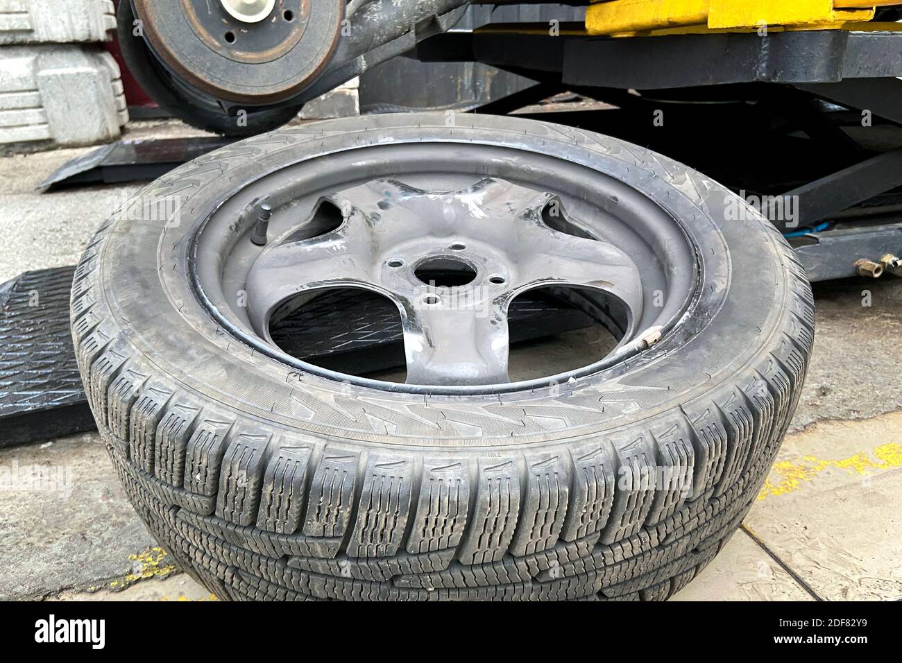 Wheel balancing or repair and change car tire. Automobile maintenance concept. Damaged tyre in