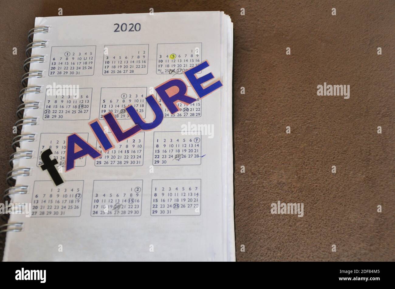 Calendar for the year 2020, printed on paper, with the inscription Failure  in cut-out letters, on a ceramic background, top-down view, with copy space  Stock Photo - Alamy