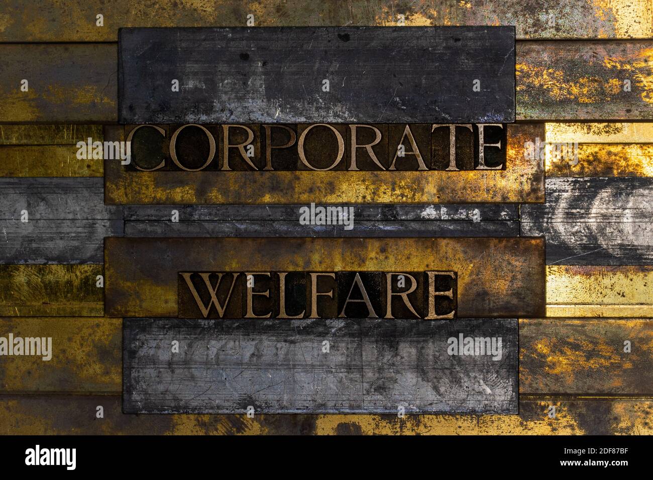 Corporate Welfare text formed by real authentic typeset letters on vintage textured grunge bronze background Stock Photo