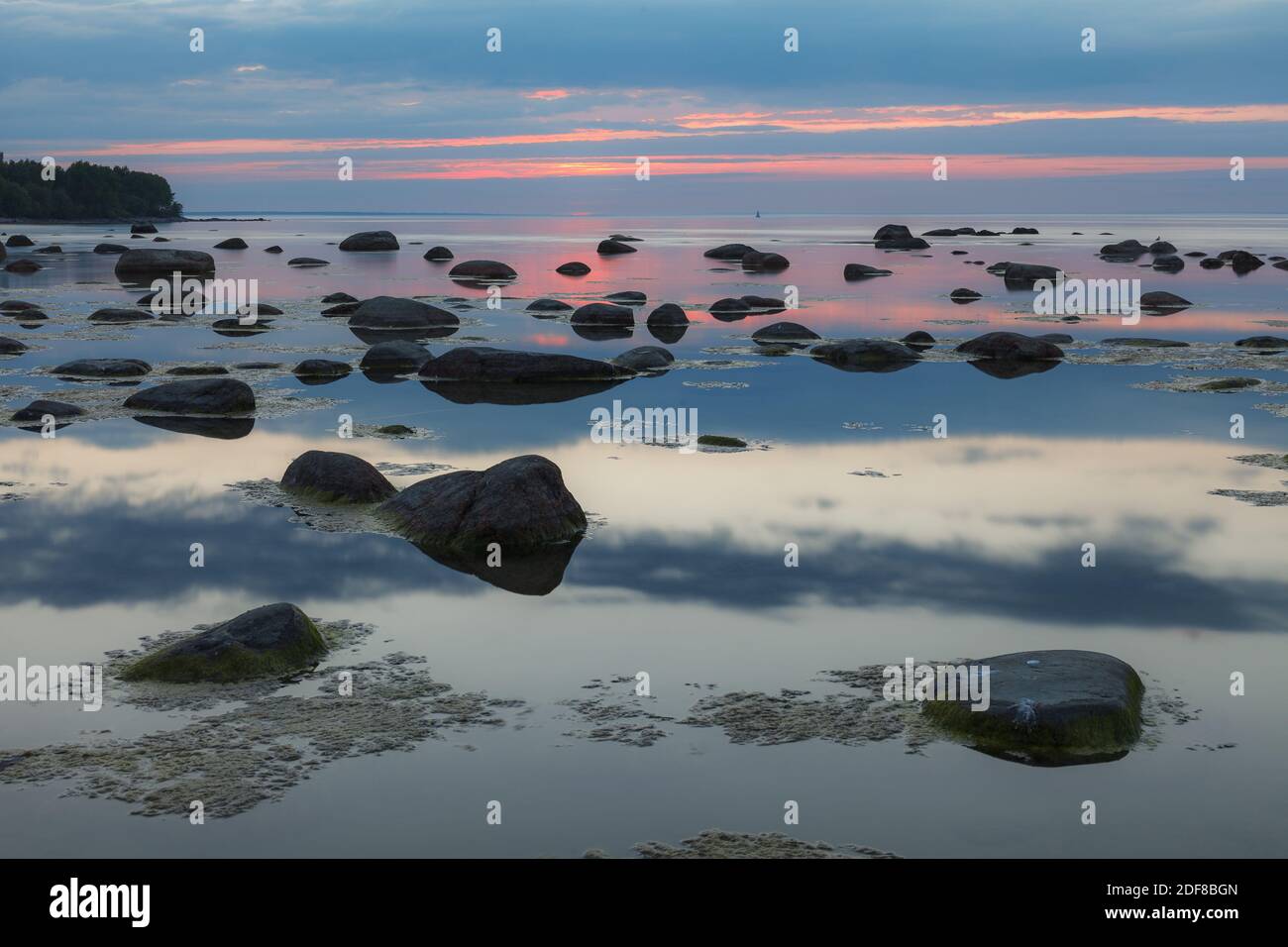 Beautiful rocky sea shore at sunset Stock Photo - Alamy