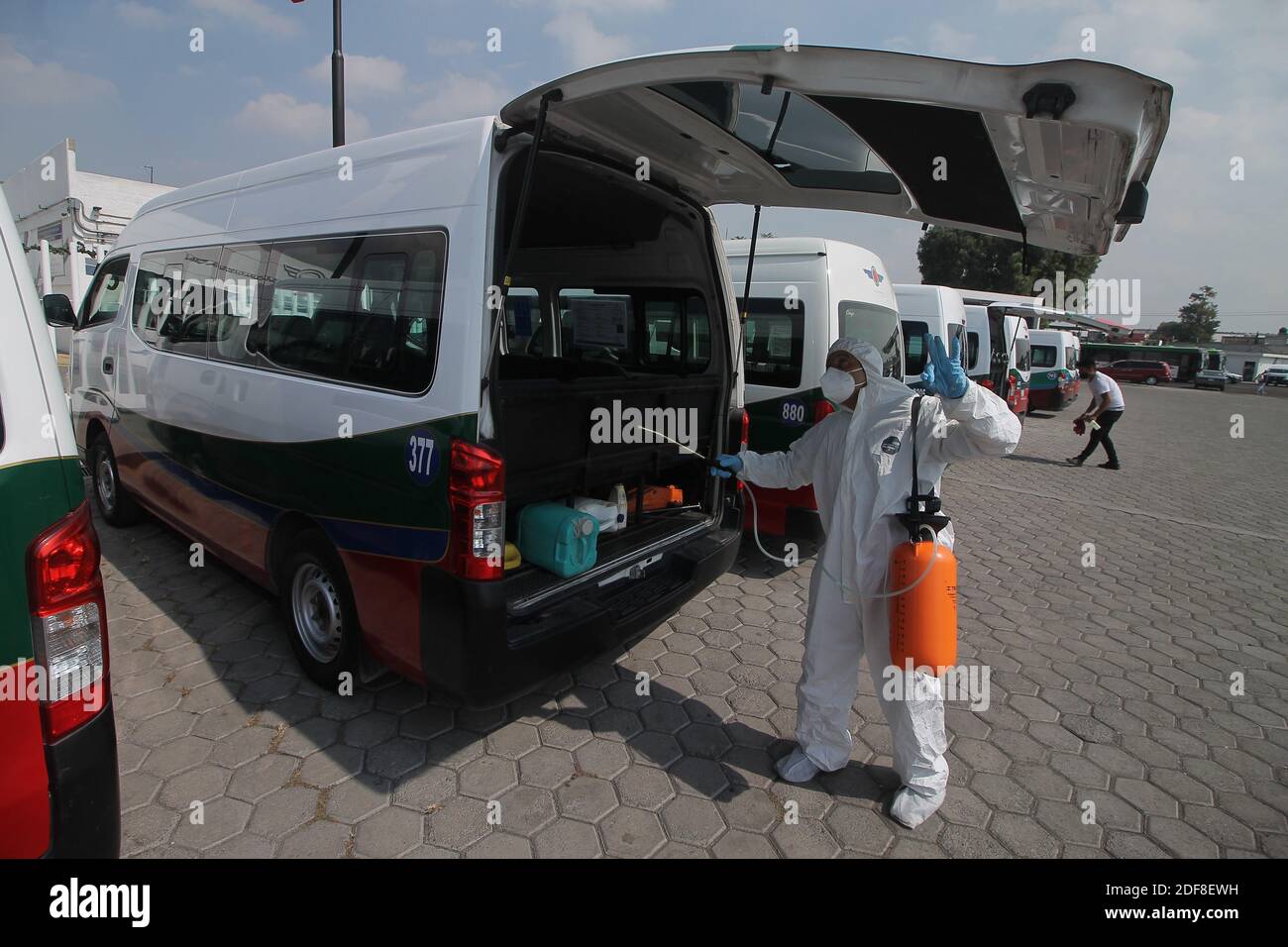 MEXICO CITY, MEXICO - DECEMBER 1: A person wears personal protective equipment suit to spray disinfectant solution on a bus station as safety measure amid the New Covid-19 pandemic as Mexico reaches 1,113,543 cases for Covid-19 on December 1, 2020 in Mexico City, Mexico. Credit: Ricardo Castelan Cruz/Eyepix Group/The Photo Access Stock Photo
