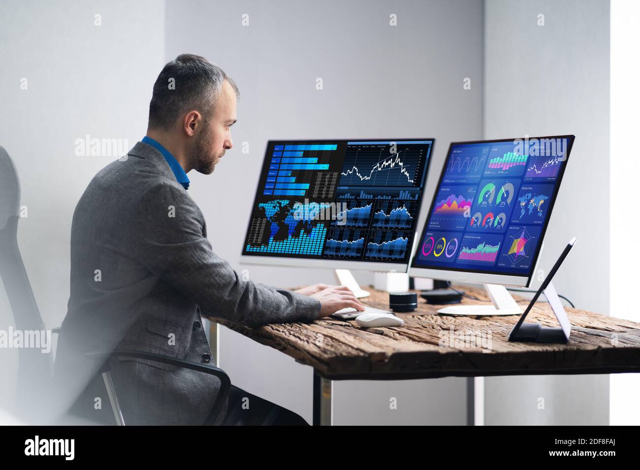 Financial Analyst Or Advisor Using KPI Data Technology On Desktop Stock Photo