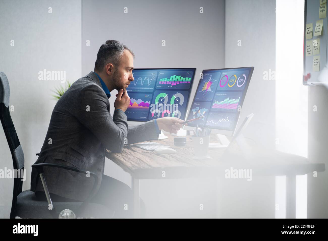 Financial Analyst Or Advisor Using KPI Data Technology On Desktop Stock Photo