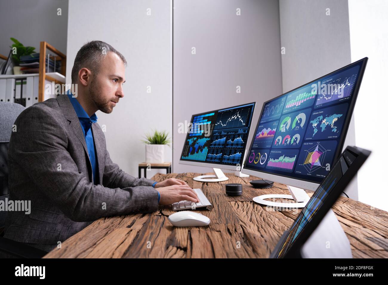 Financial Analyst Or Advisor Using KPI Data Technology On Desktop Stock Photo