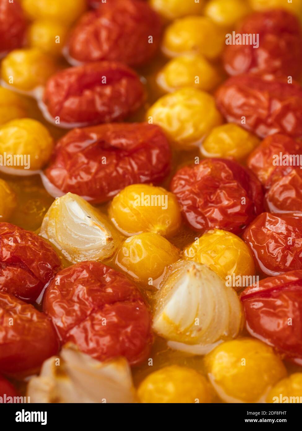 Roasted cherry tomatoes and physalis in a baking dish Stock Photo