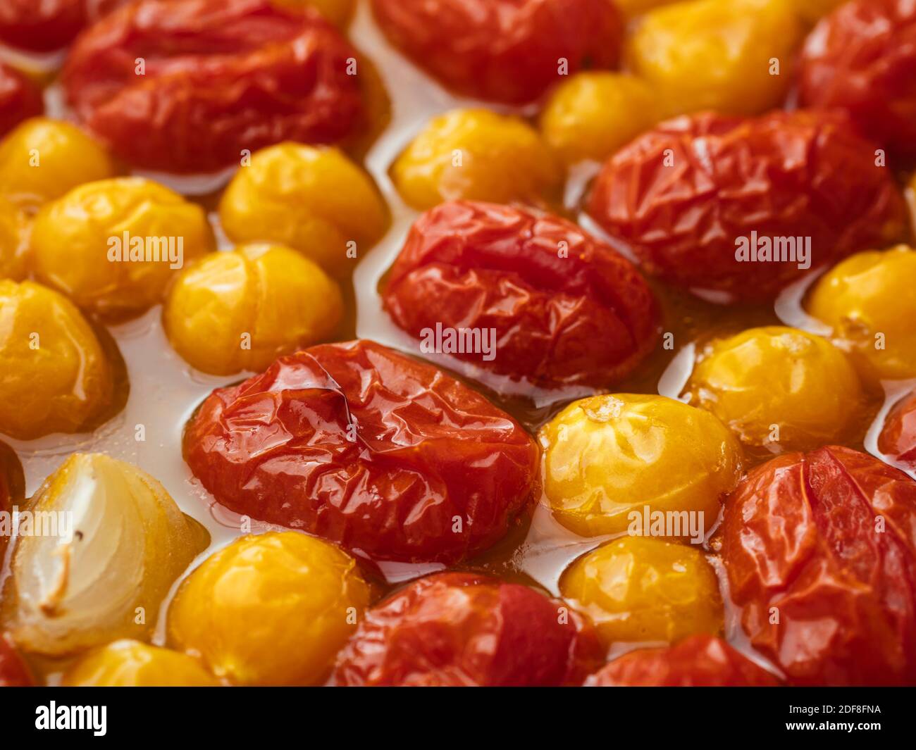 Roasted cherry tomatoes and physalis in a baking dish Stock Photo