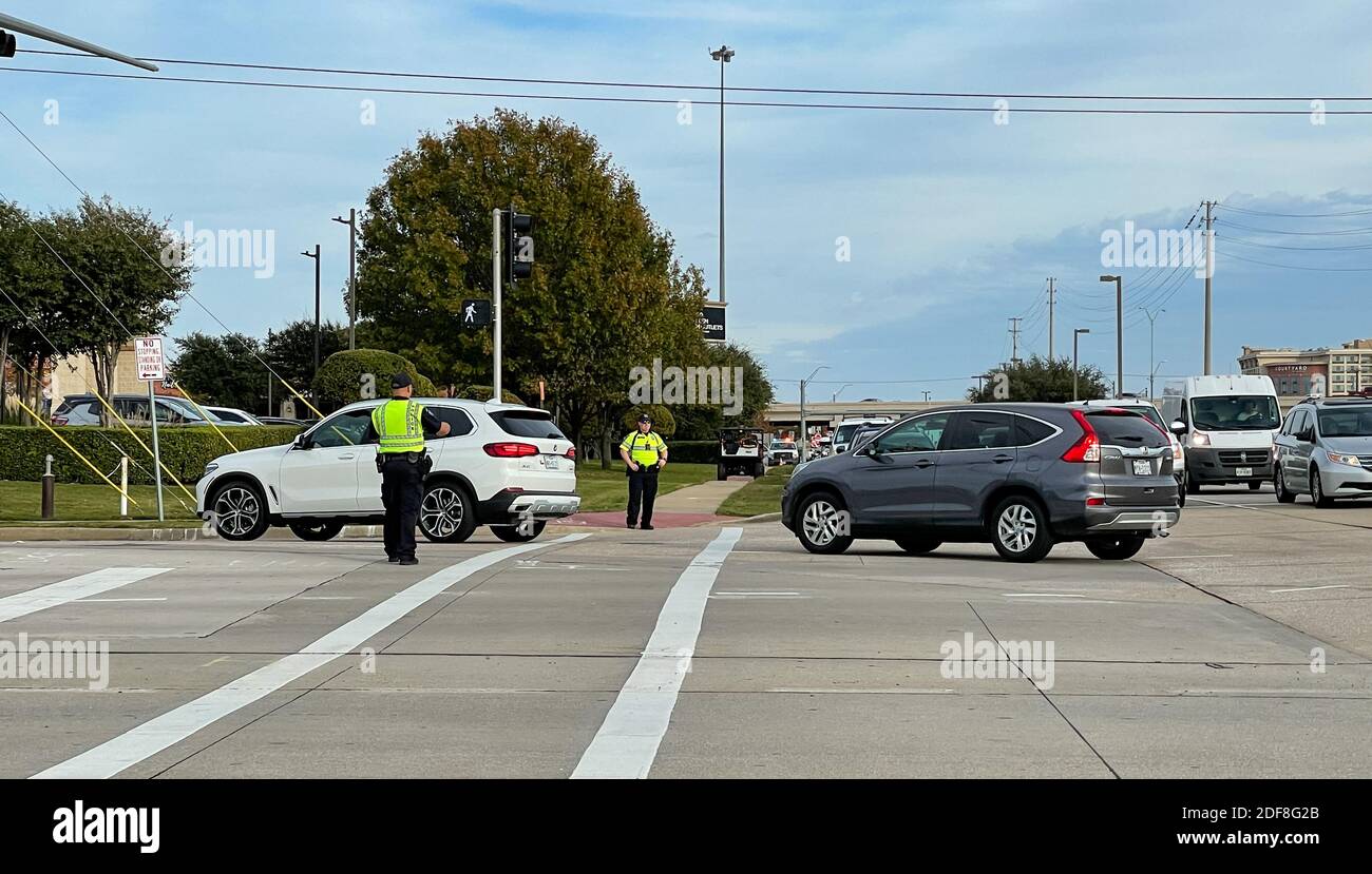 Allen, TX USA - November 27, 2020: Roadside view of police officers guiding the cars of the traffic Stock Photo