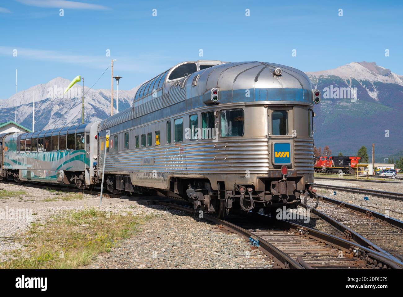 Train Of VIA Rail Canada In Front Of Mountain Range, Jasper, Canada Stock Photo