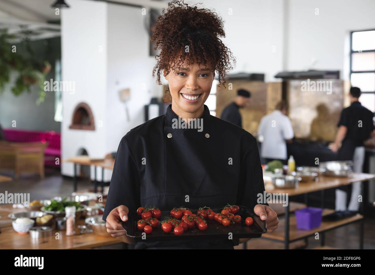 Female chef and divserse group in kitchen Stock Photo
