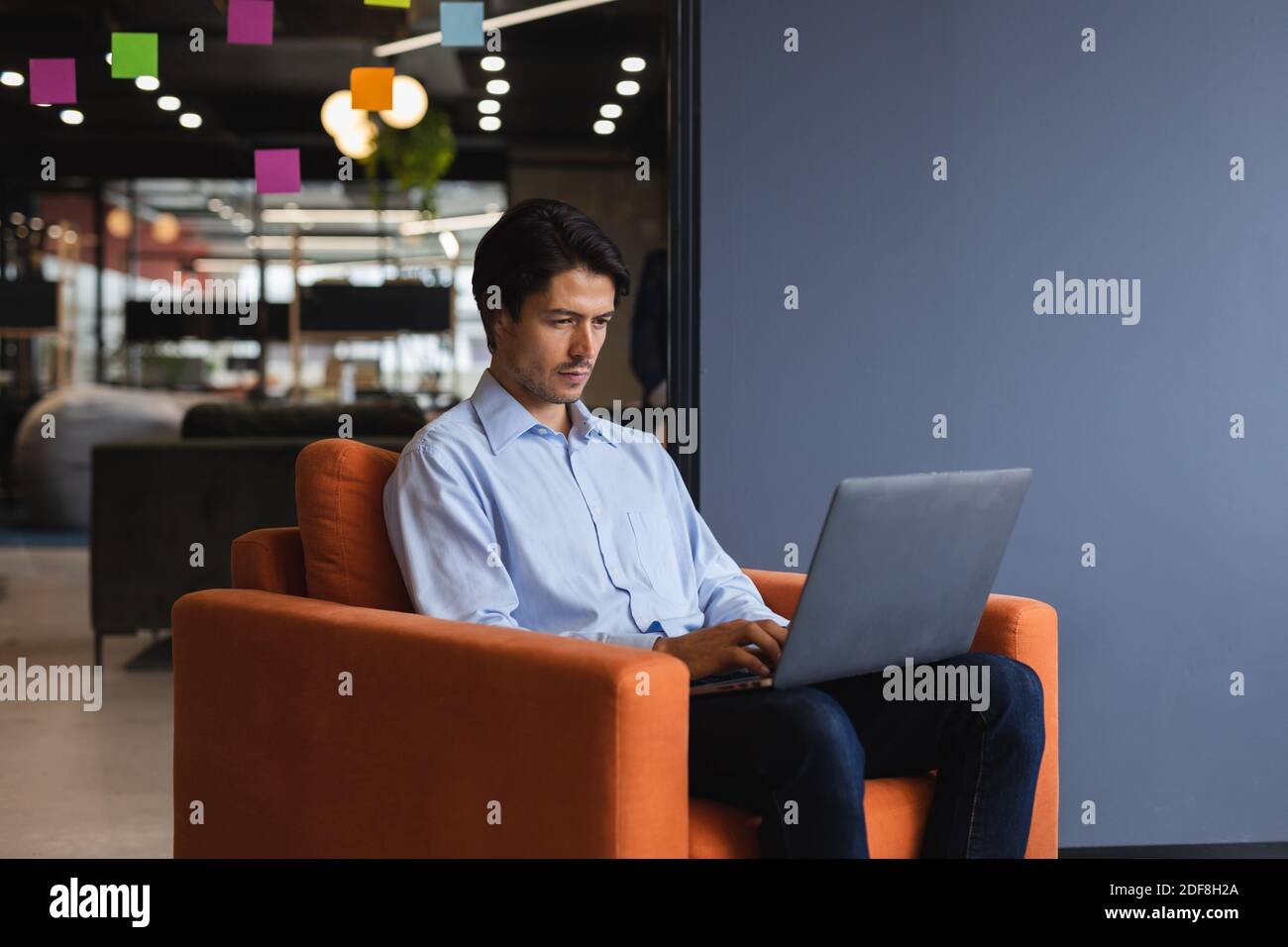 Caucasian businessman using laptop computer in creative office Stock Photo