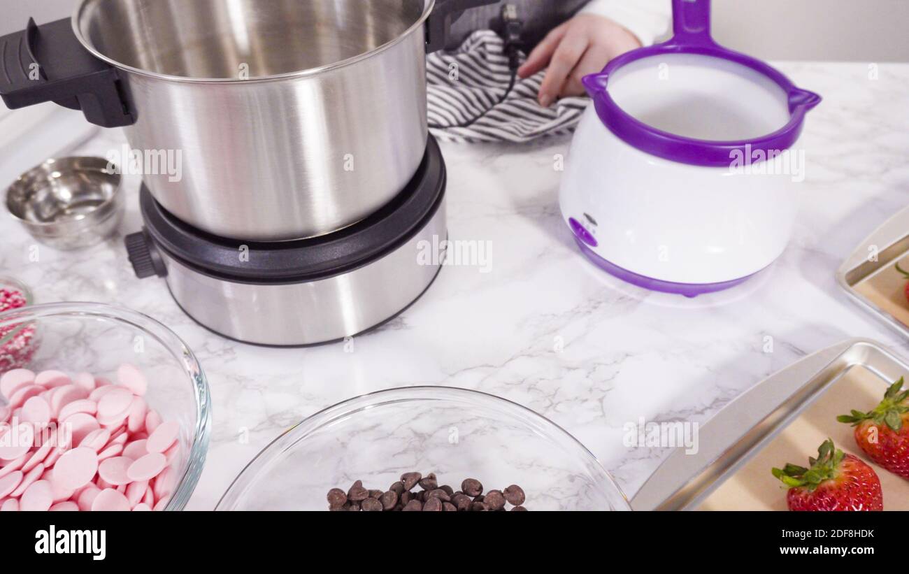 Step by step. Melting chocolate chips in chocolate melting pots Stock Photo Alamy