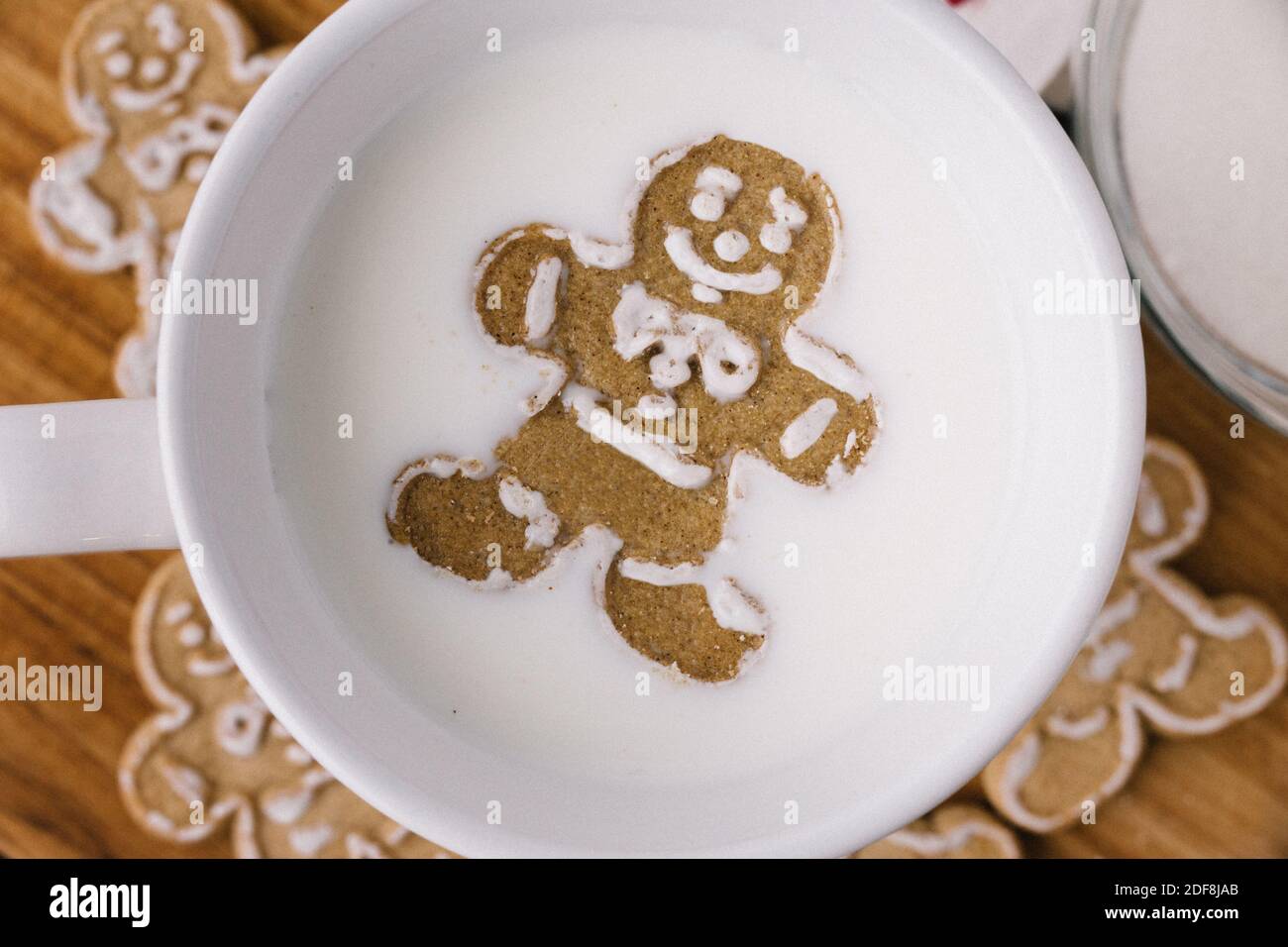 Christmas Holiday Ginger Bread Man Cookie Floating In Mug Of Milk Stock Photo