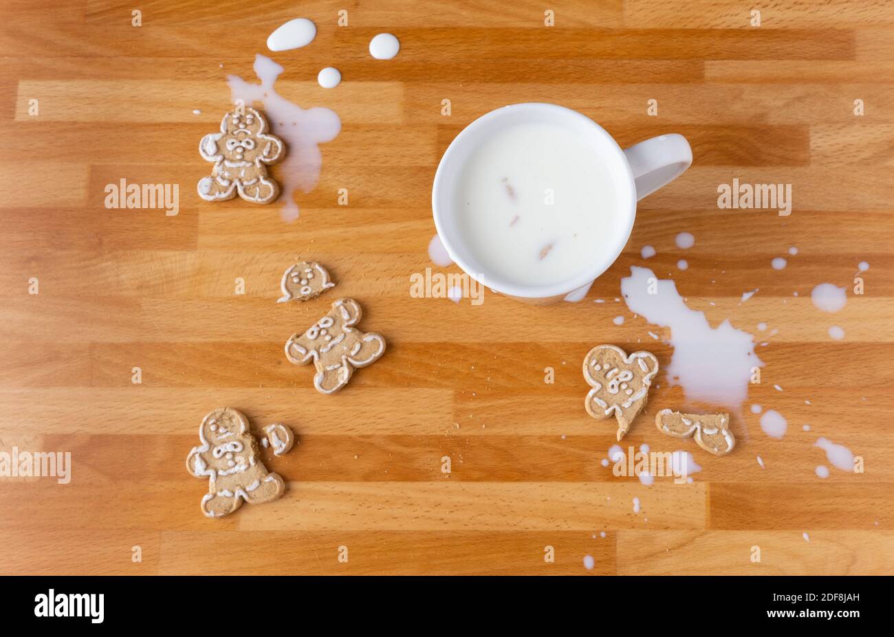 Broken Gingerbread Man Cookies And Spilt Milk Stock Photo