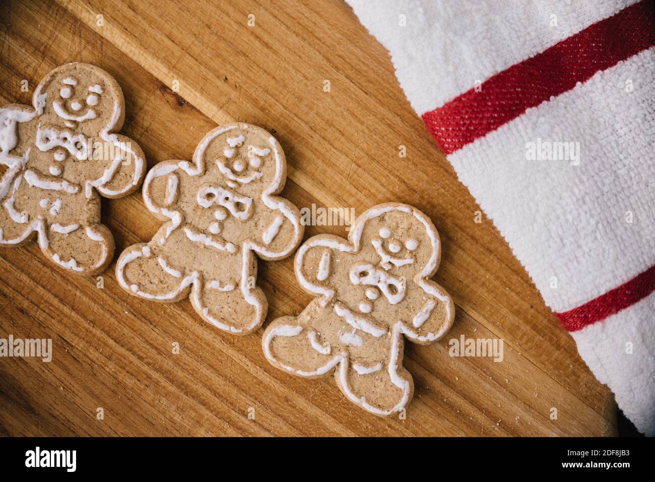 Christmas Gingerbread Man Cookies on Wooden Board Stock Photo