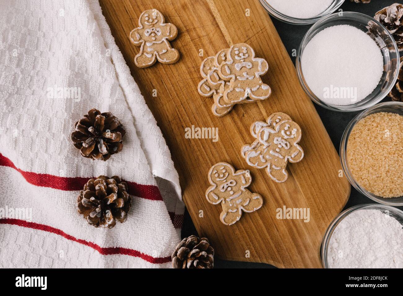 Christmas Gingerbread Man Cookies on Wooden Board With Ingredients Stock Photo