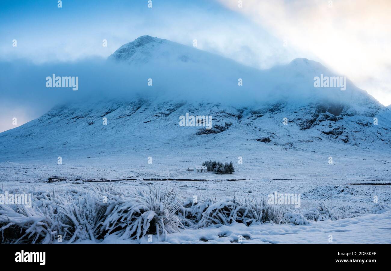Glen Coe, Scotland, UK. 3 December 2020. A cold front has brought the first snowfall to the Scottish Highlands. Rannoch Moor and Glen Coe are covered in several inches of snow. Bright sunshine throughout the day created beautiful winter landscapes.  Pictured; Solitary cottage in the snow.  Iain Masterton/Alamy Live News Stock Photo