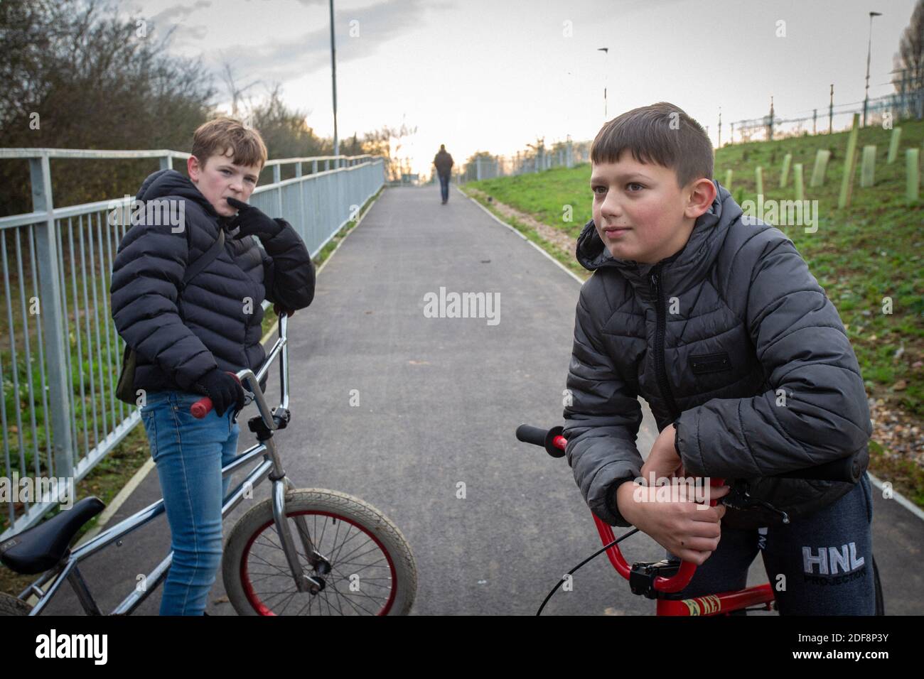 GREAT BRITAIN / KENT / Ashford /Children with bicycles near construction site of post-Brexit lorry park near Sevington,Ashford in Kent. Stock Photo