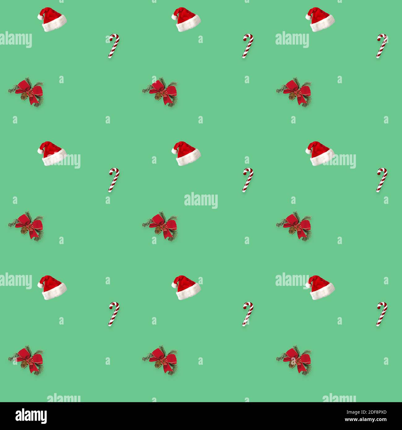 seamless pattern Santa hat, bow and candy cane candy cane on green background Stock Photo