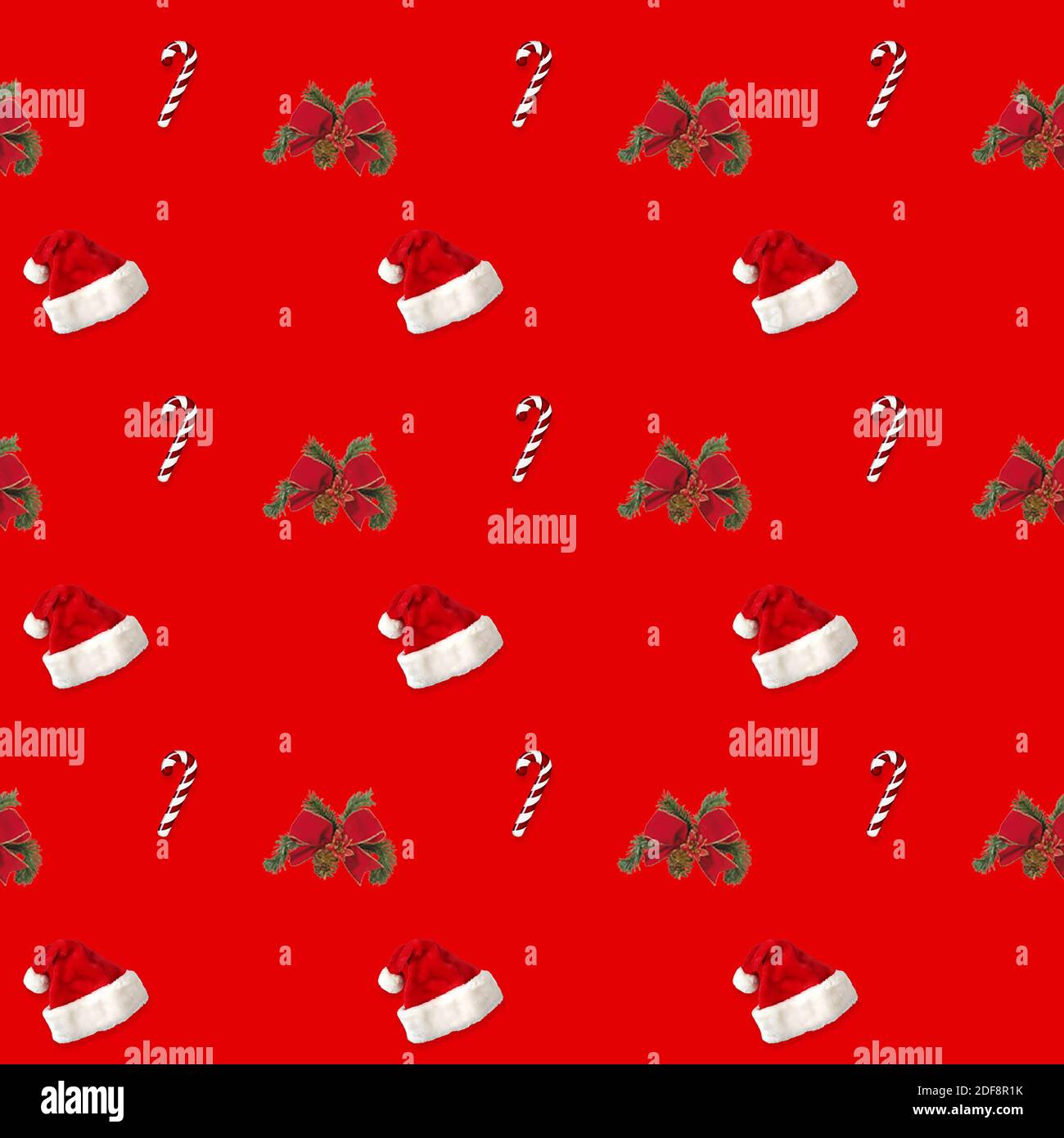 seamless pattern Santa hat and candy cane candy cane on red background Stock Photo