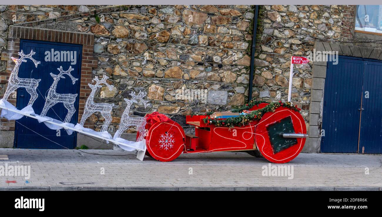 Santa’s  Sleigh and his reindeer parked on the pier in Howth, Dublin, Ireland preparing to take off to the North Pole. Stock Photo