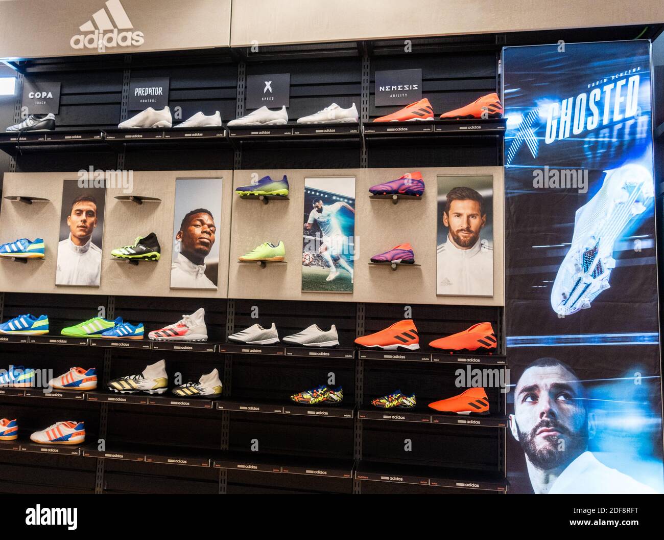 Adidas football boots store display. Messi, Pogba... Stock Photo