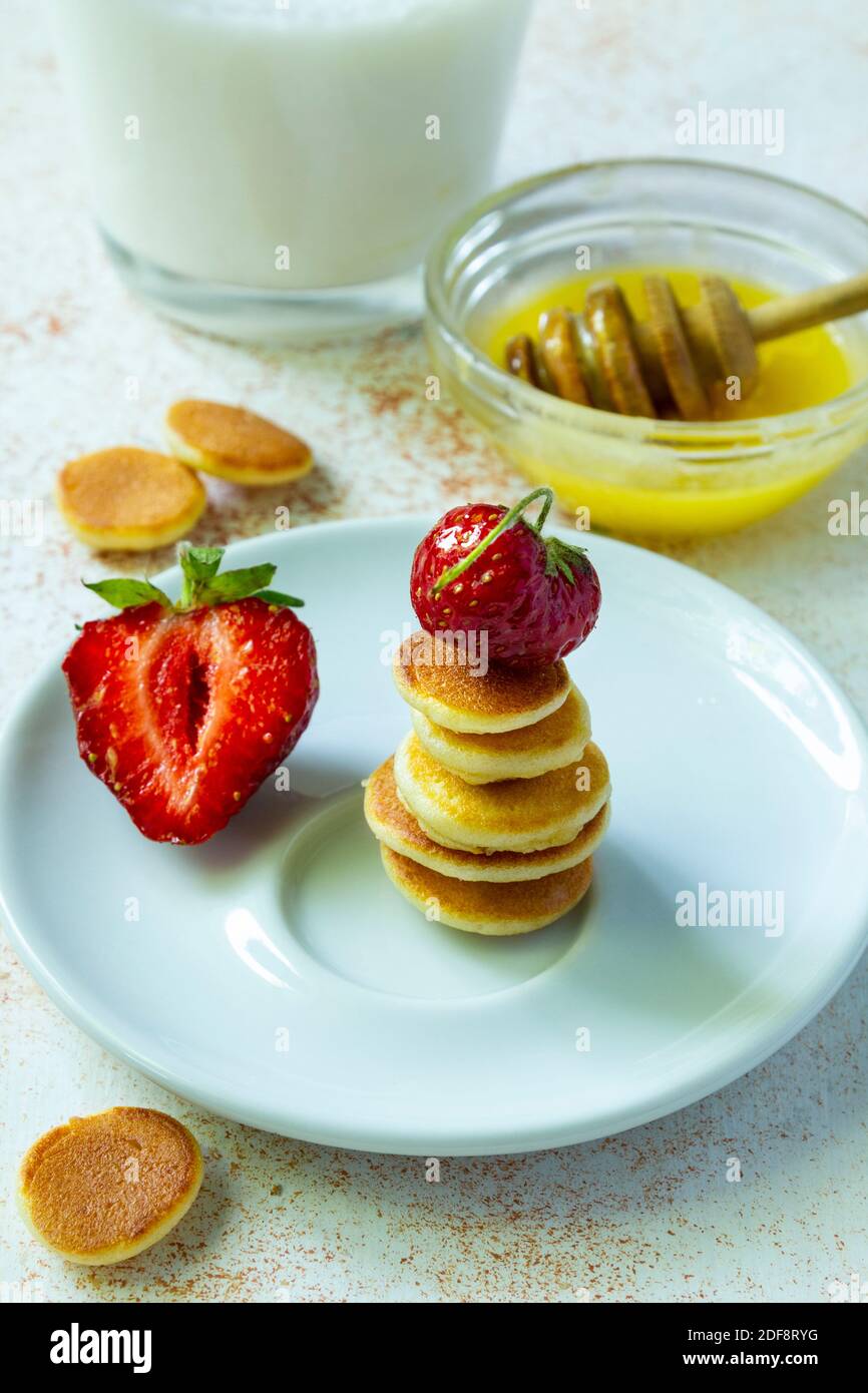 Trendy food pancake cereal. Stack of mini cereal pancakes with