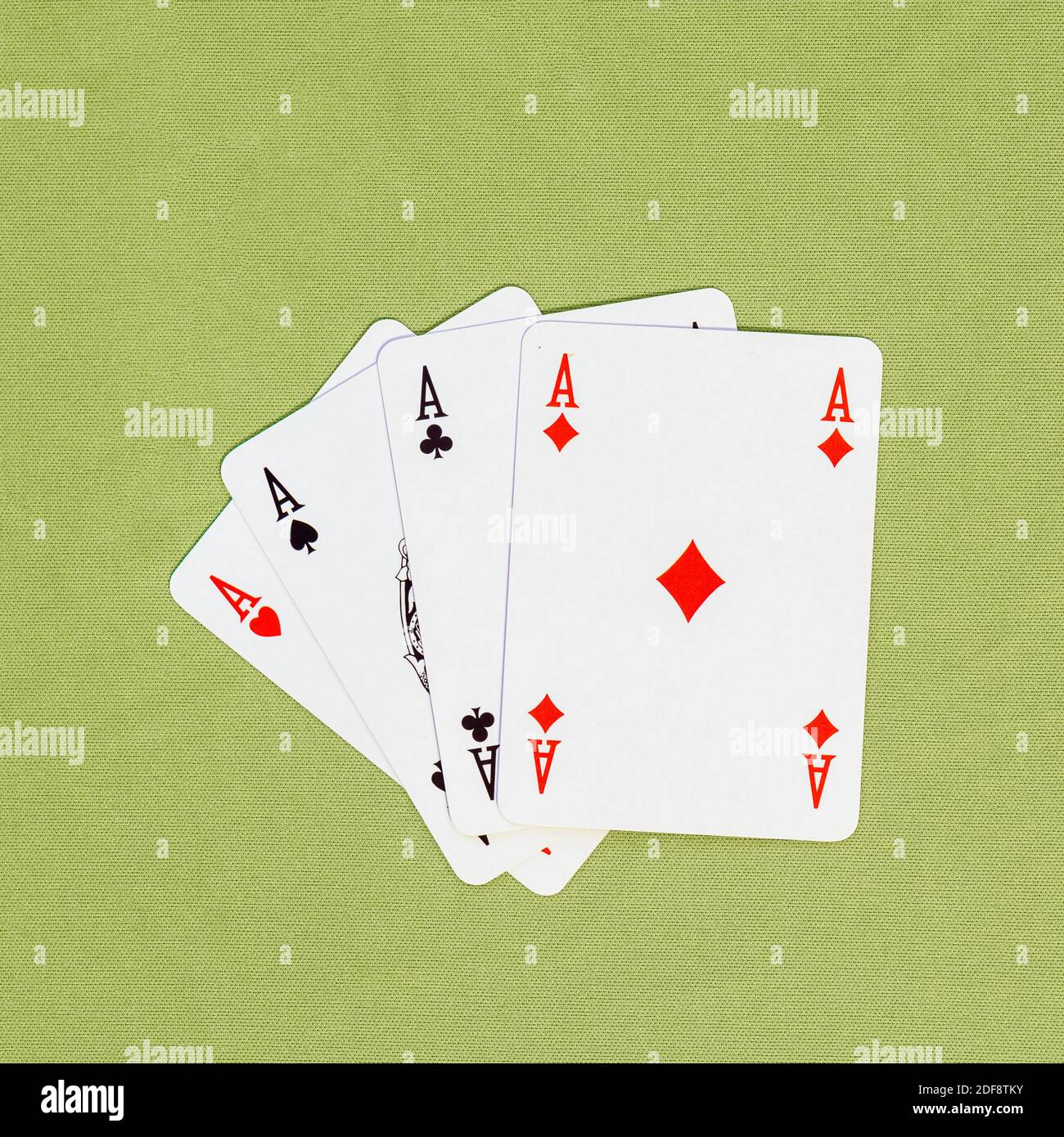 Four playing cards depicting aces, clubs, spades, diamonds, hearts on a