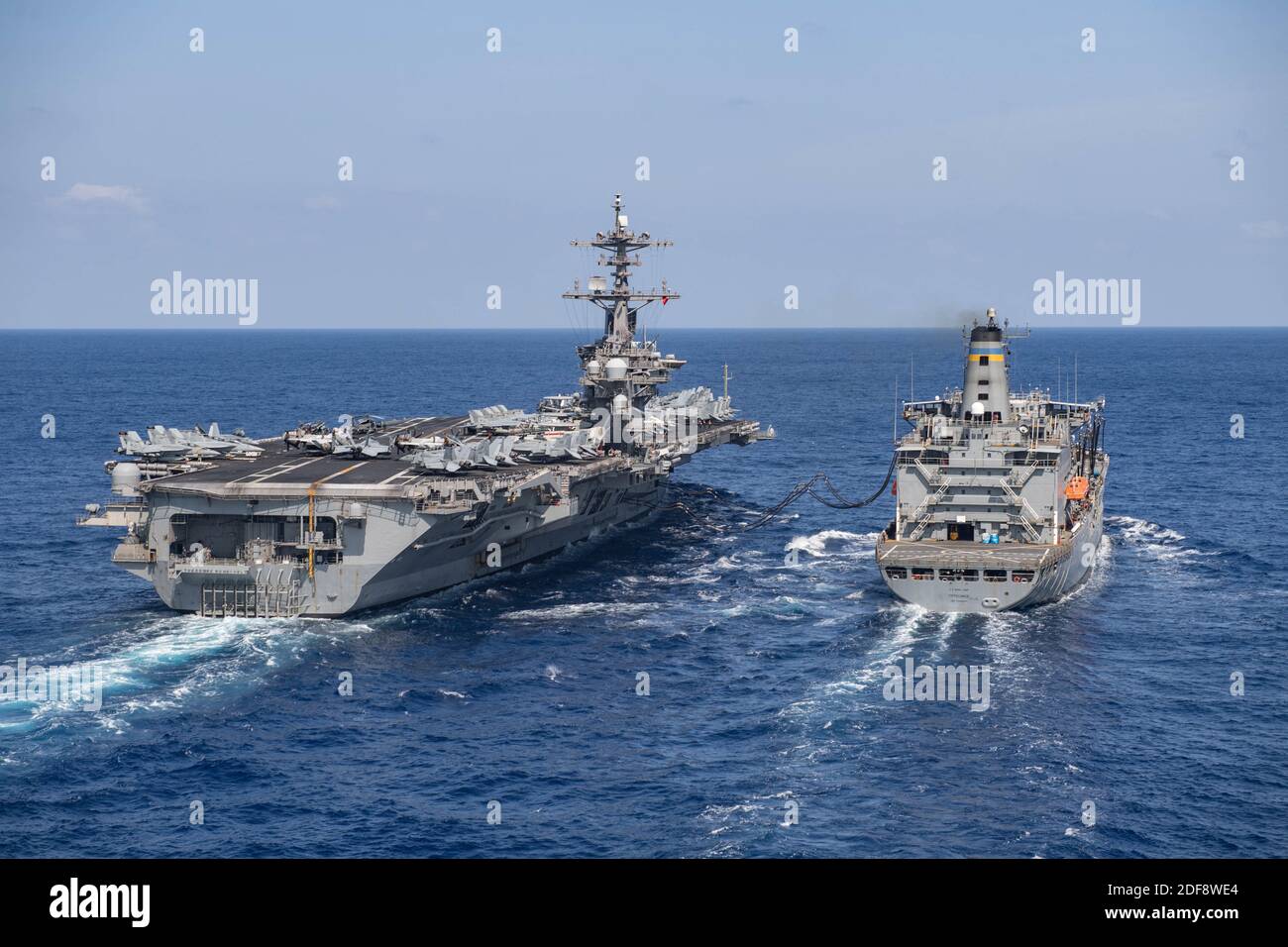 Handout file photo dated March 17, 2020of the aircraft carrier USS Theodore Roosevelt (CVN 71) receives fuel from the fleet replenishment oiler USNS Tippecanoe (T-AO 199) in the China Sea. Brett Crozier, captain of nuclear aircraft carrier Theodore Roosevelt, with more than 100 sailors infected with the coronavirus pleaded Monday with U.S. Navy officials for resources to allow isolation of his entire crew and avoid possible deaths in a situation he described as quickly deteriorating. Photo by US Navy via ABACAPRESS.COM Stock Photo