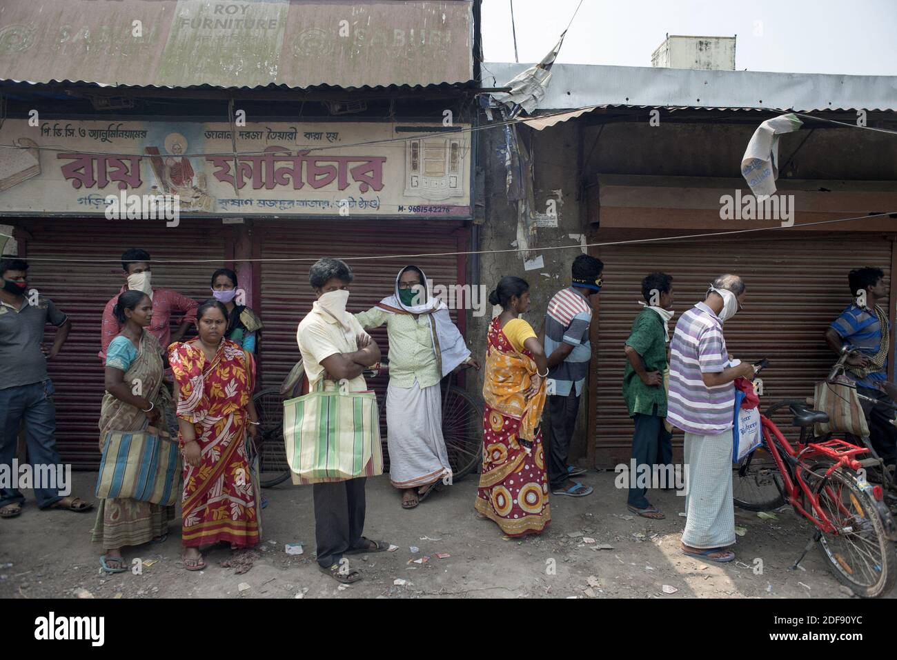 Indian people queue up for ration at a government controlled shop in ...