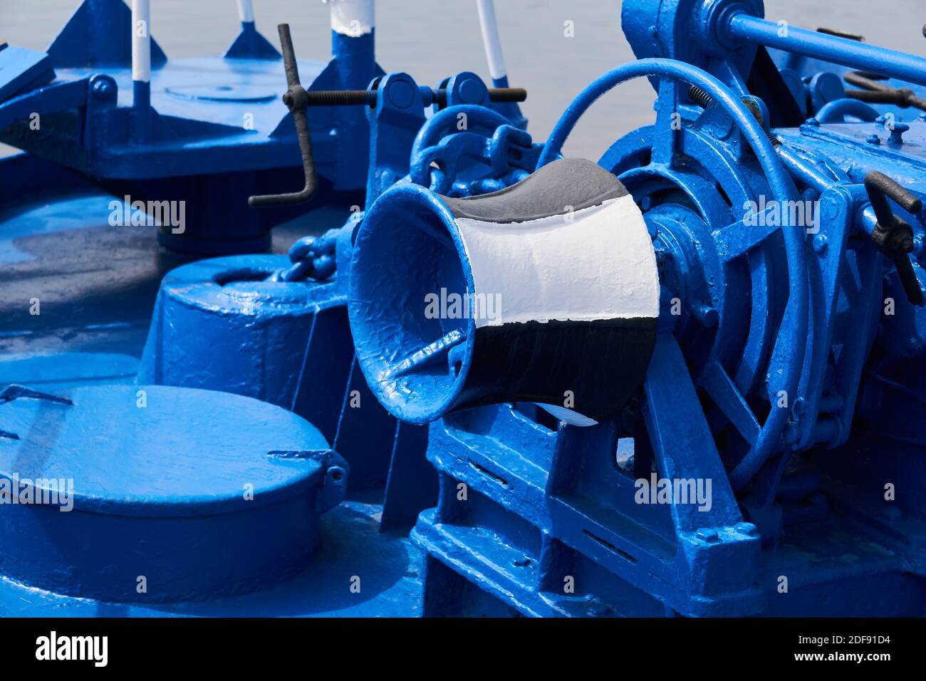 anchor windlass, capstan and other mechanisms, painted blue, on the