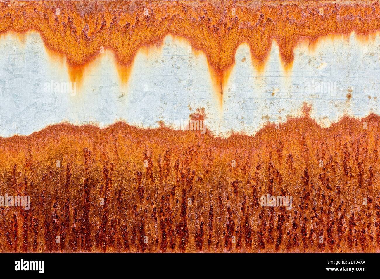 Orange rust patterns on a galvanised steel metal surface Stock Photo
