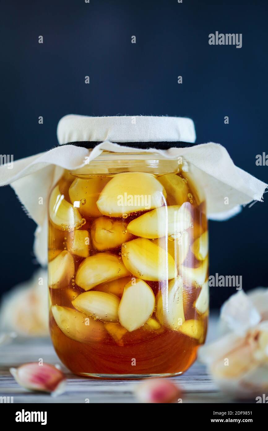 Fermented garlic cloves in a jar of honey, a rich source of probiotics