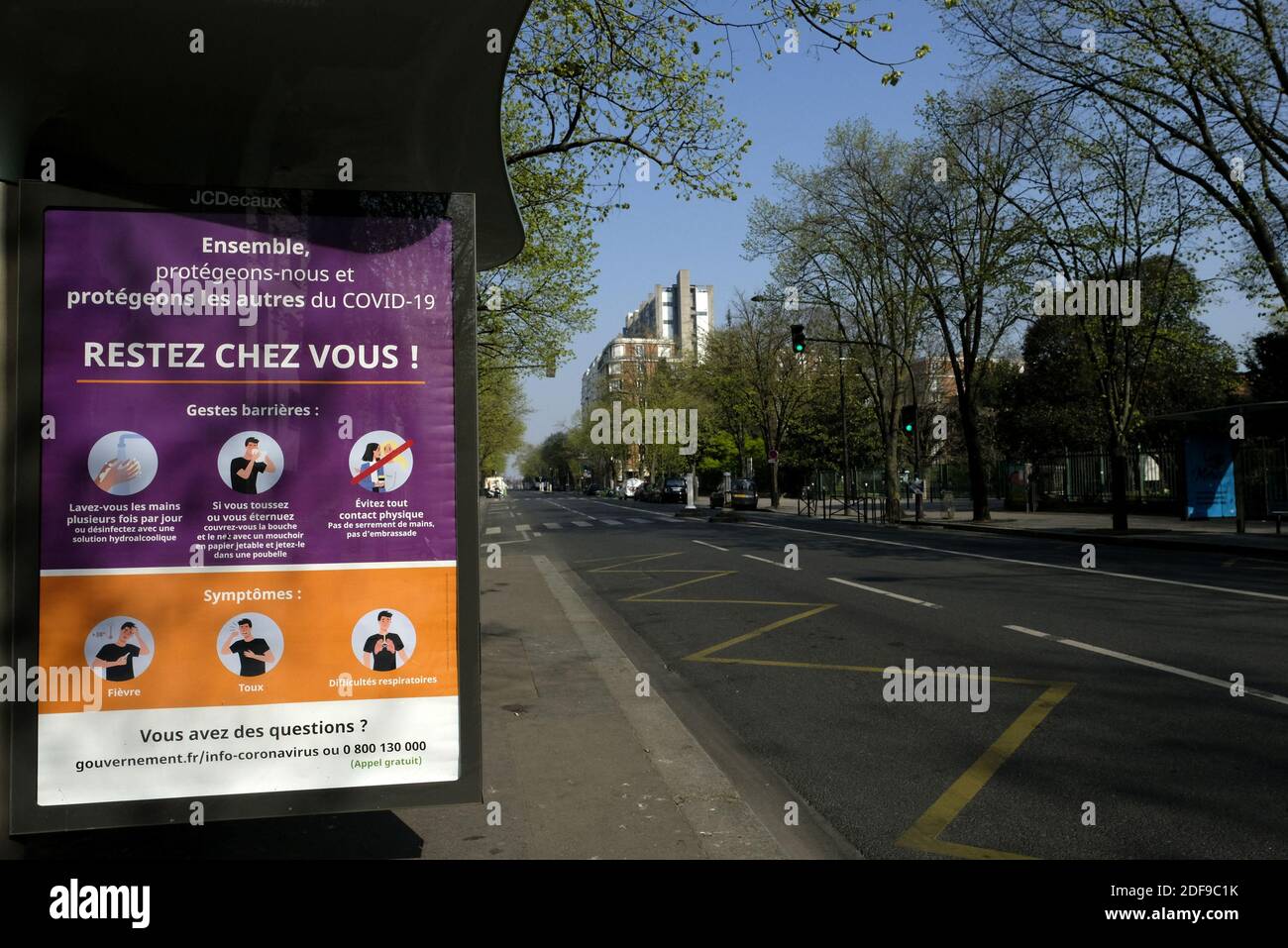 A poster reading Restez chez vous 'Stay at home' at Avenue de Choisy in Paris, as a strict lockdown comes into in effect in France to stop the spread of COVID-19. after the announcement by French President Emmanuel Macron of the strict home confinement rules of the French due to an outbreak of coronavirus pandemic (COVID-19) on March 18, 2020 in Paris, France. the French will have to stay at home, France has closed down all schools, theatres, cinemas and a range of shops, with only those selling food and other essential items allowed to remain open. under penalty of sanctions, prohibiting all Stock Photo