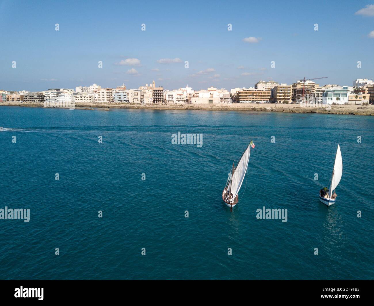 Puglia: latin sail boat sailing in Gallipoli bay view from air Stock Photo