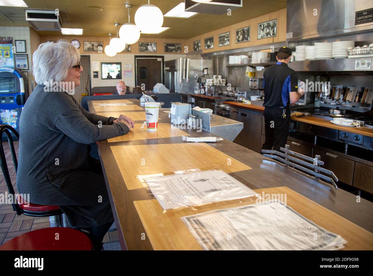 NO FILM, NO VIDEO, NO TV, NO DOCUMENTARY - Kim Kaseta waits for her pattie  melt while sitting at the counter at the Waffle House in Brookhaven Monday,  April 27, 2020. Photo