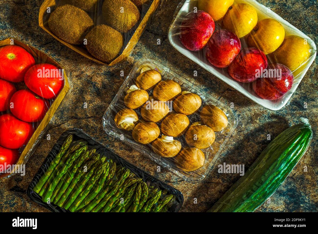 Plastic waste in stores. Fruits and vegetables packed in plastic wrappers that inundate supermarkets. Stock Photo