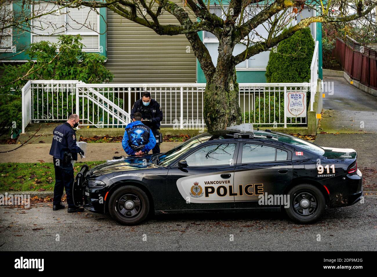 Vancouver Police, handcuff and arrest young man on street, Vancouver