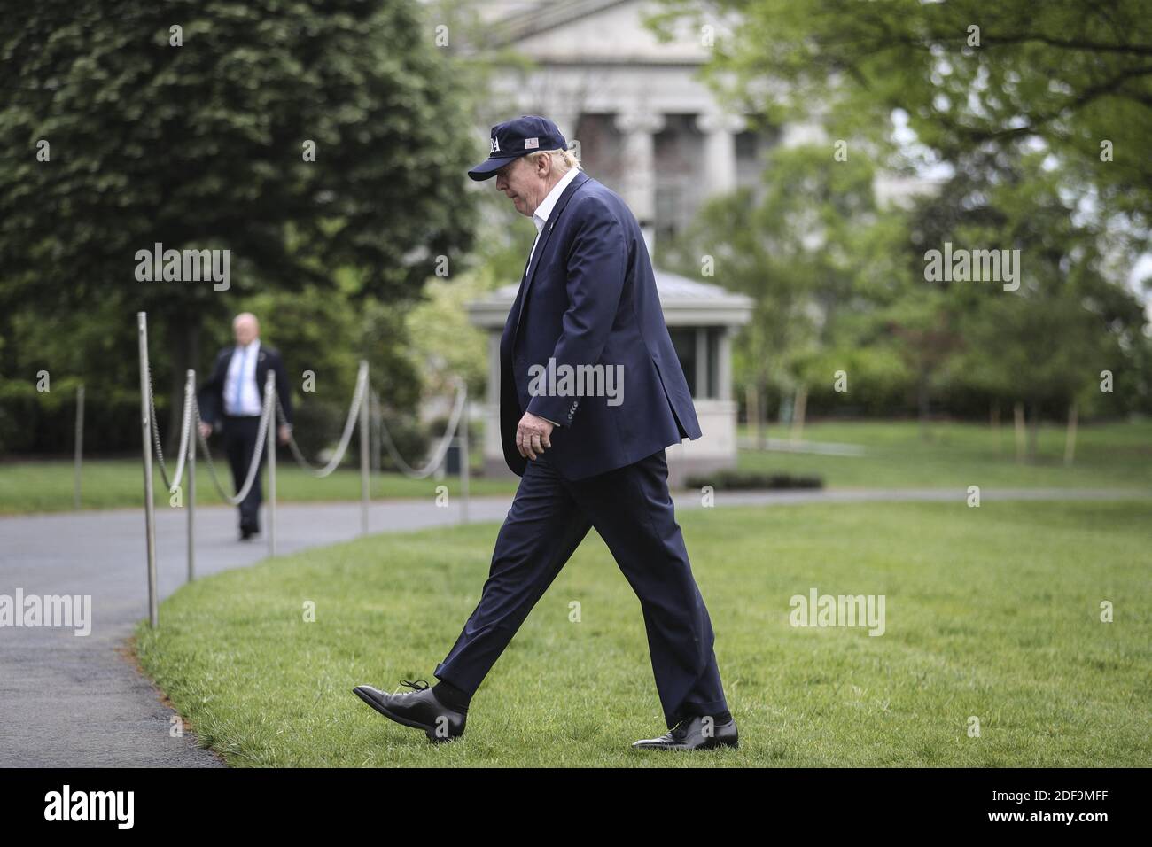 President Donald Trump walks on the South Lawn of the White House as he ...